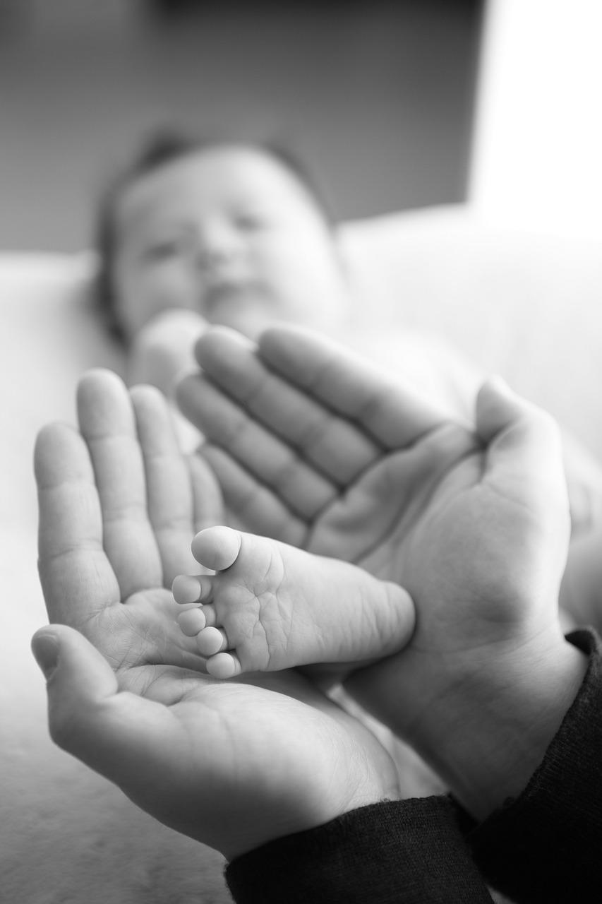 dad holding baby's foot